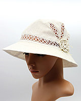 Женская льняная шляпа с полями и украшением.